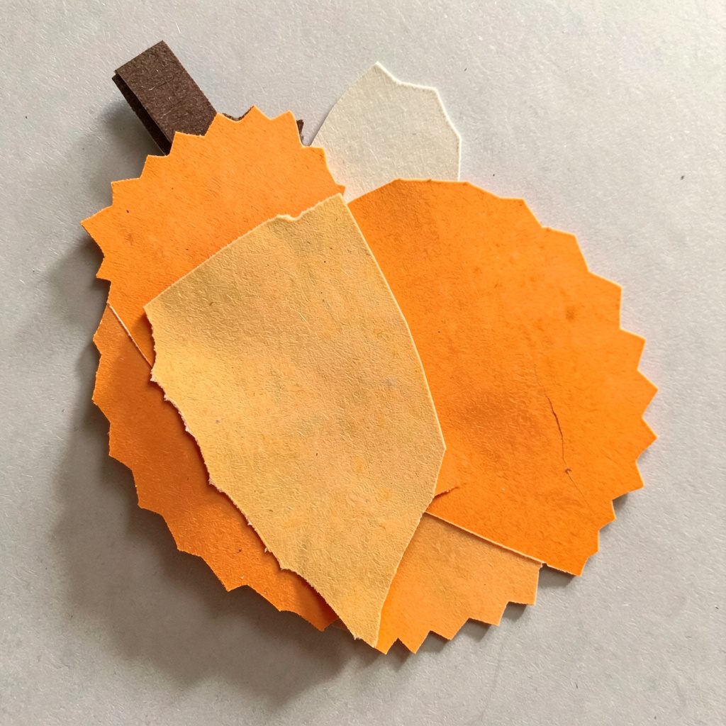 A layered paper cut-out collage of a spiky durian fruit rendered in orange and black tones, dramatic and moody