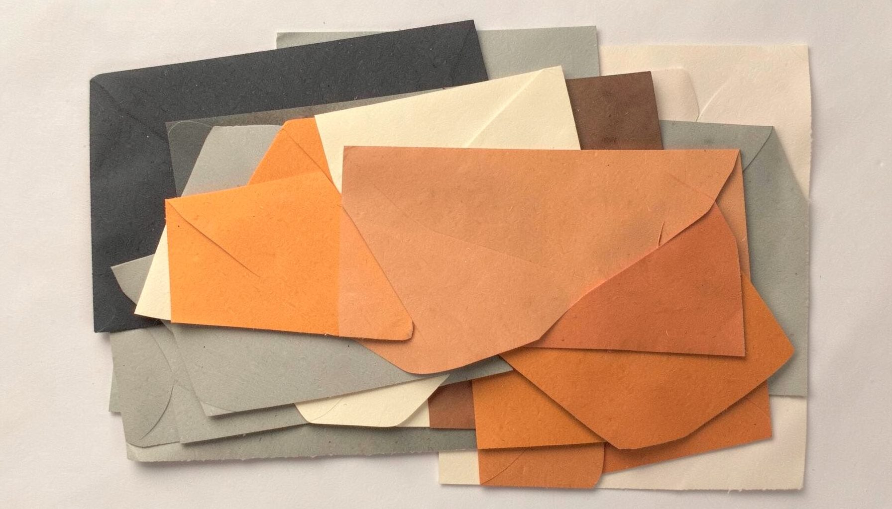 Layered paper cut-out collage of overlapping charcoal, cream, and burnt orange rectangles suggesting ledgers and stacked envelopes, in muted neutral tones with warm highlights.